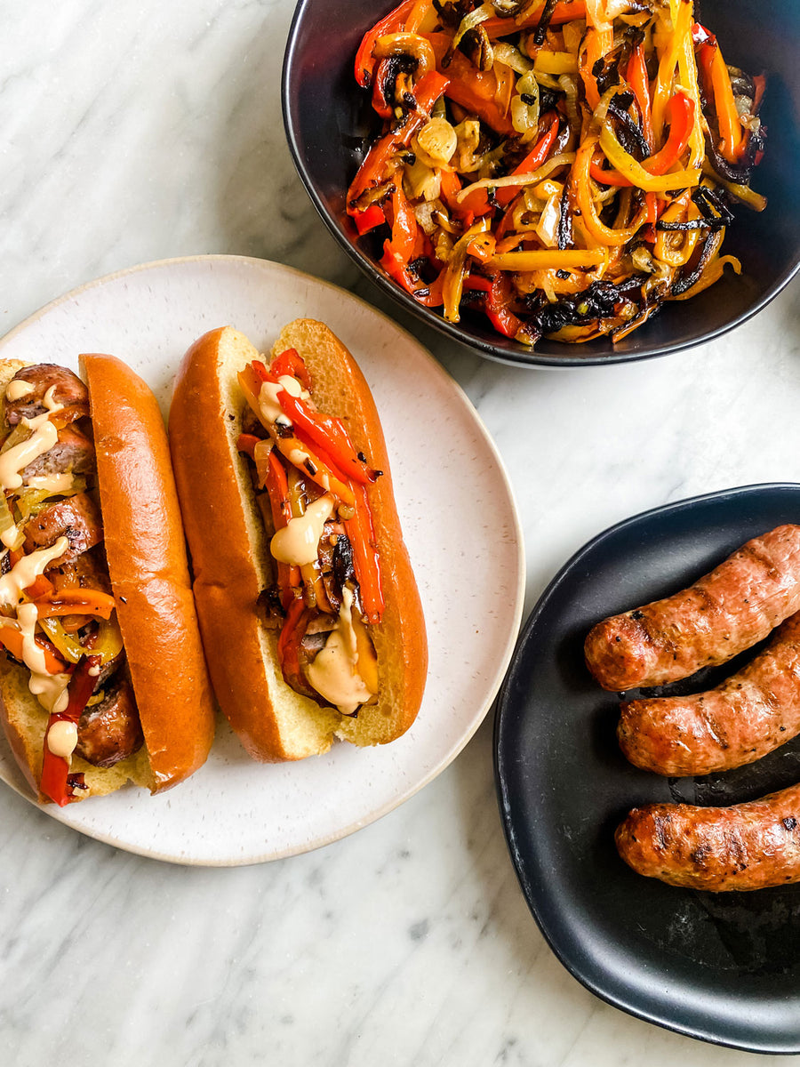 Sausage on Brioche Rolls with Peppers and Onions Longhini Sausage Co